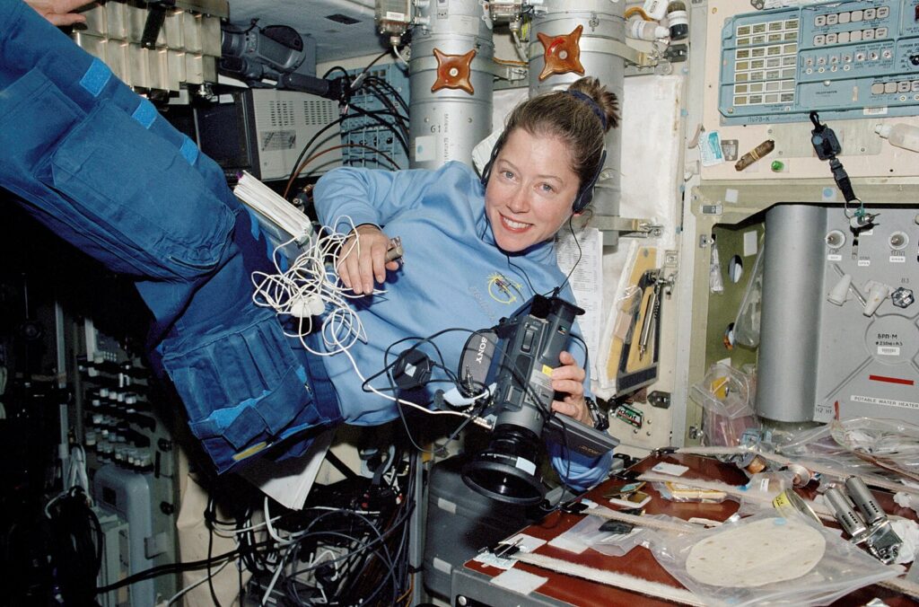 Col. Pamela Melroy wears a blue scrunchie while on a space mission in 2002.